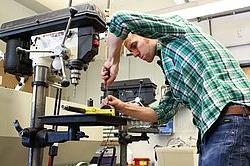 Mechanical engineering student working on a lathe machine